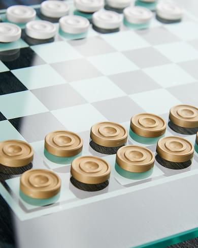 Checkers board with gold and silver pieces